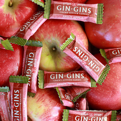 The Ginger People Gin Gins Chewy Ginger Apple Candy on red apples