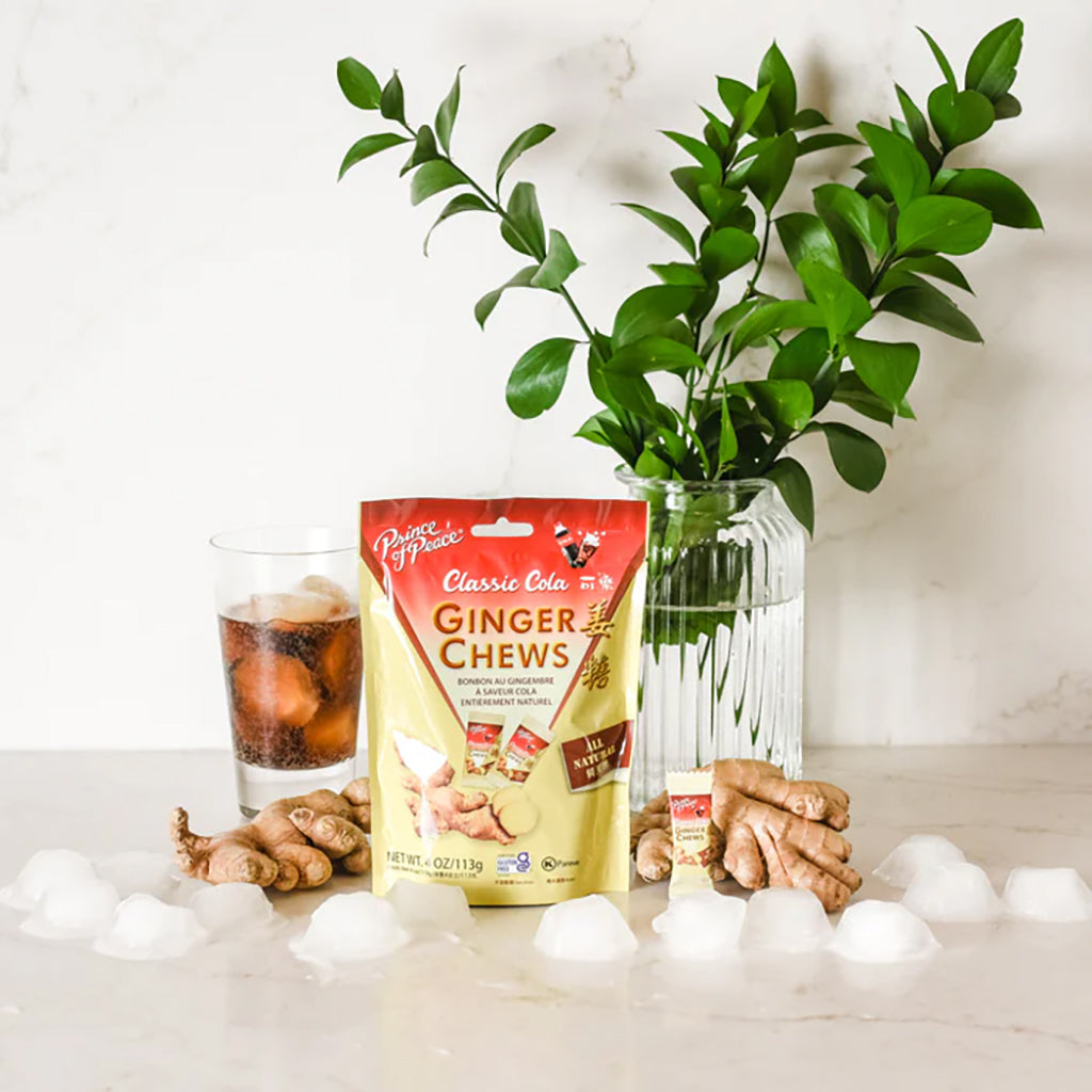 Prince of Peace Classic Cola Ginger Chews with a drink, ginger root and plant