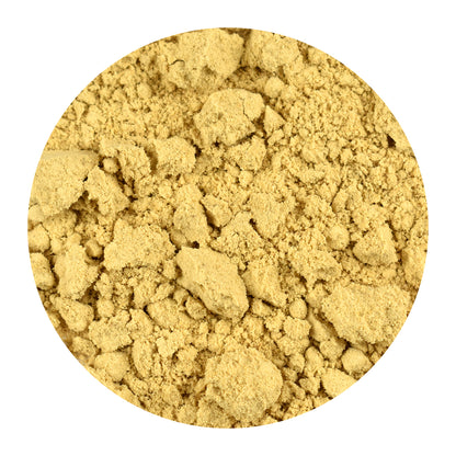 Close-up of bulk ginger root powder on a white background