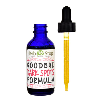 Open bottle of Herb Stop Goodbye Dark Spots Formula with a full dropper next to the bottle.