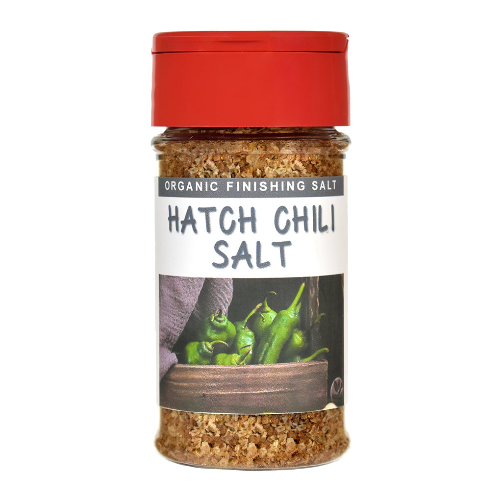 Jar of organic Hatch Chili finishing salt with a red lid and label showing green chilies.