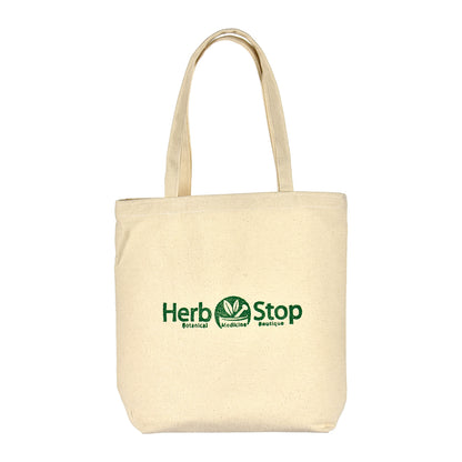 Beige tote bag with 'Herb Stop' logo on a white background