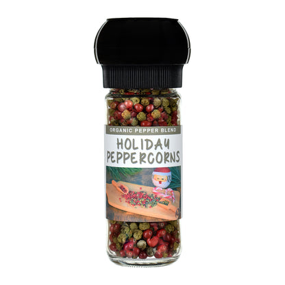 Jar of holiday peppercorns with a grinder lid on a white background