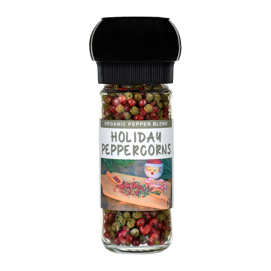 Jar of holiday peppercorns with a grinder lid on a white background