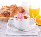 Hot Belly Pig Tea Infuser with orange juice and croissants