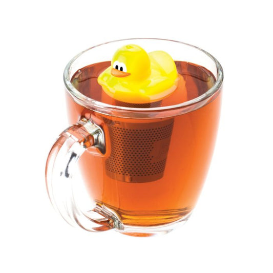 Clear glass mug with a rubber duck tea infuser and tea inside on a white background