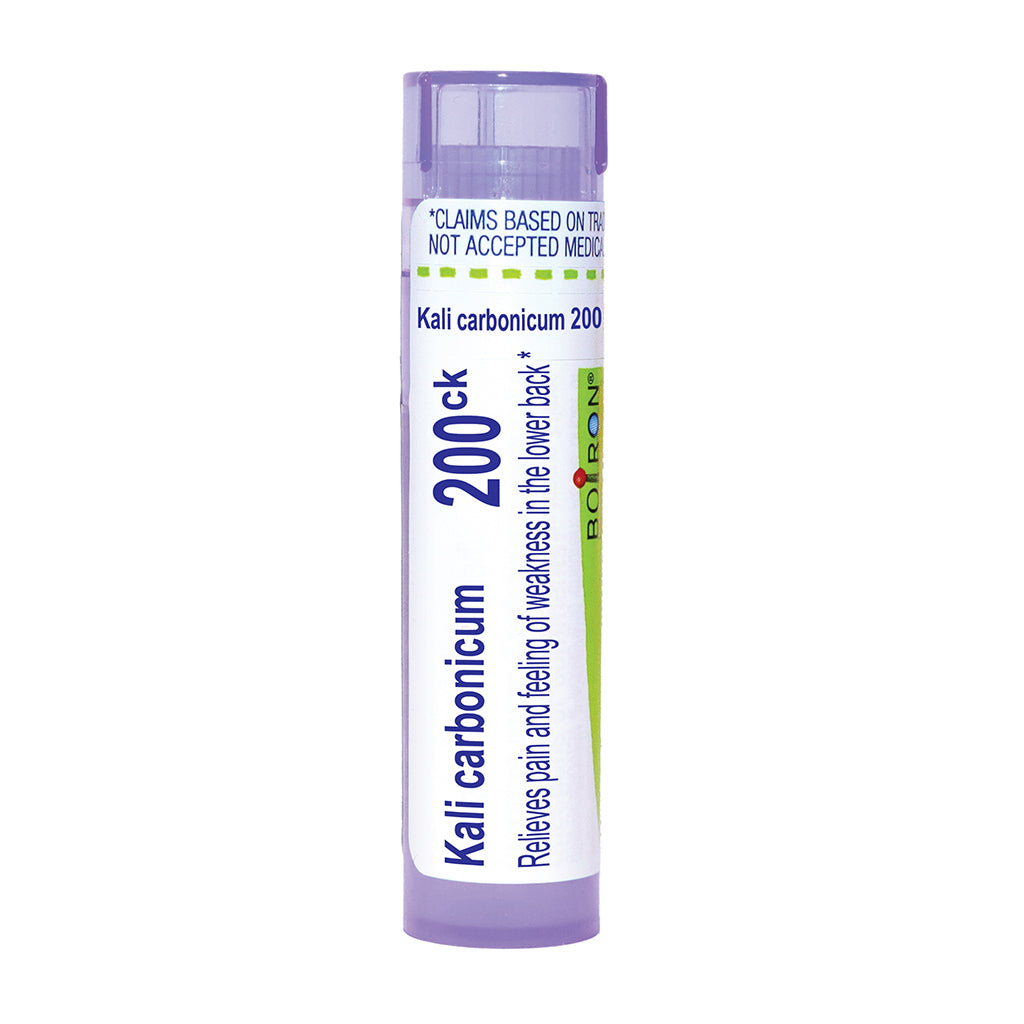 A single tube of Boiron Kali carbonicum 200ck homeopathic medicine, featuring a white label with blue and green text and accents, and a light purple cap and base, on a solid white background.
