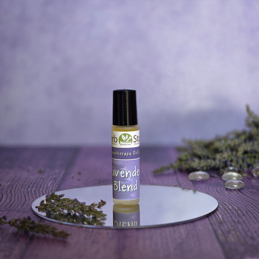 Aromatherapy roll-on bottle of Herb Stop Lavender Blend on a reflective surface with a blurred purple background