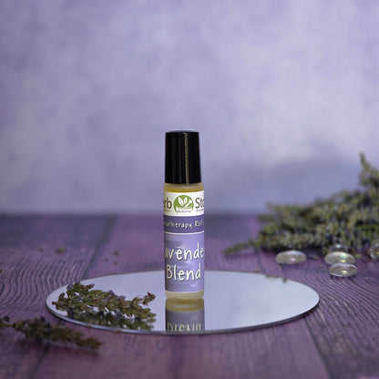Aromatherapy roll-on bottle of Herb Stop Lavender Blend on a reflective surface with a blurred purple background