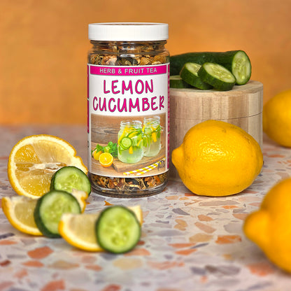 Jar of Herb Stop Lemon Cucumber Herb and Fruit Tea with lemons and cucumbers on a table.