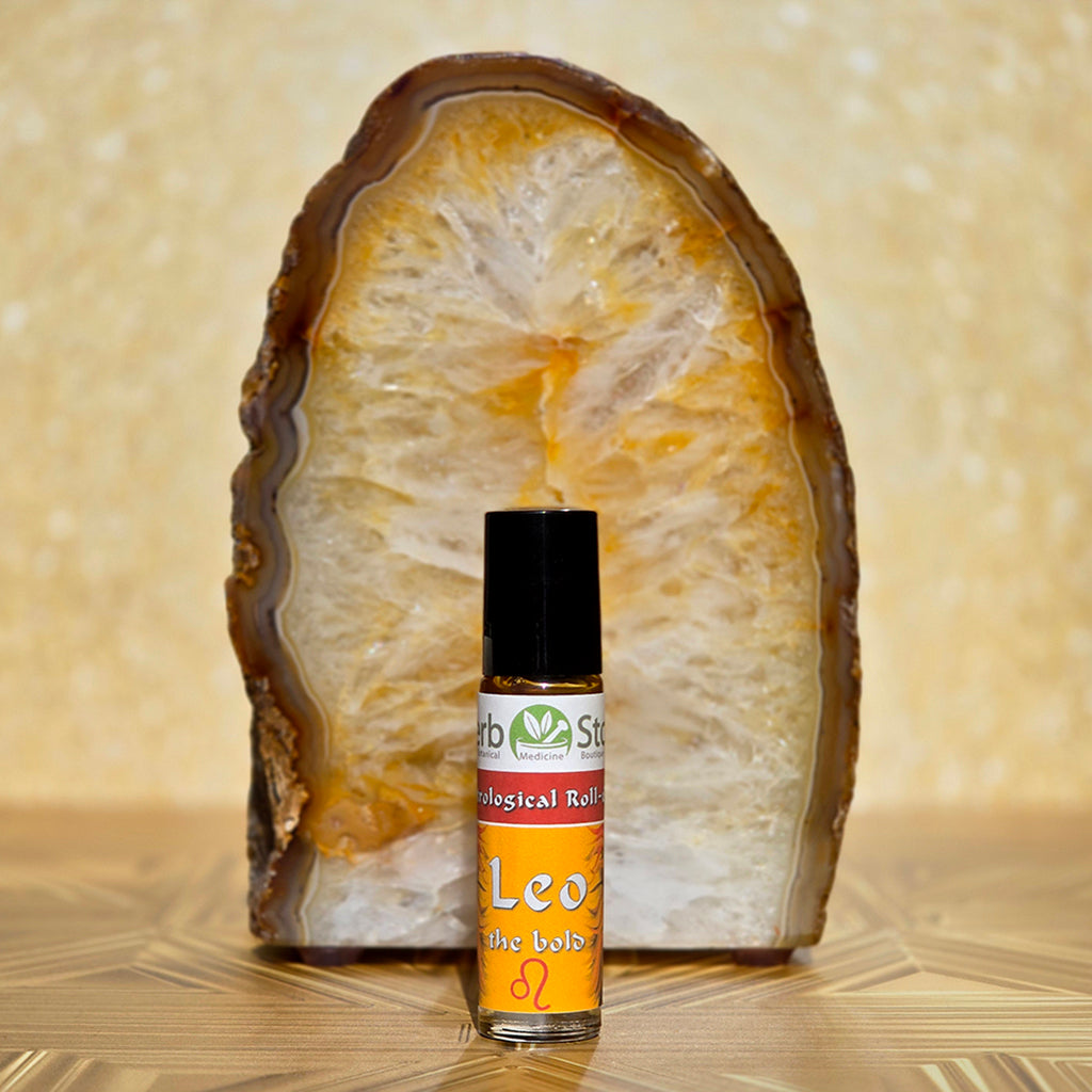 Leo Aromatherapy Roll-on bottle with a citrine crystal on a decorative background