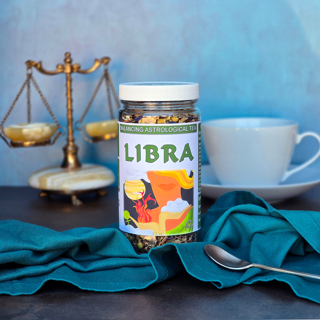 Jar of Libra astrological tea with a cup and decorative scale in the background