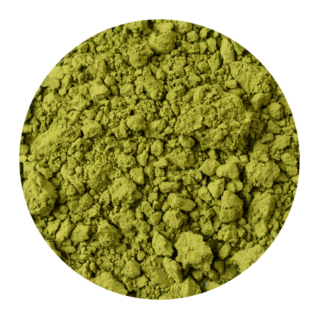 Close-up of organic matcha powder on a white background