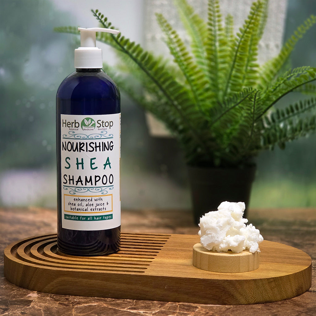 Herb Stop Nourishing Shea Shampoo bottle on a wooden tray with a plant in the background