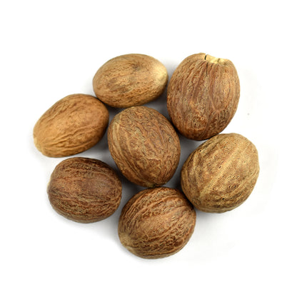 A group of whole organic nutmeg on a white background 