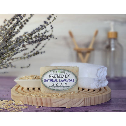 Herb Stop's Oatmeal Lavender Soap surrounded by bathroom items on a purple surface 