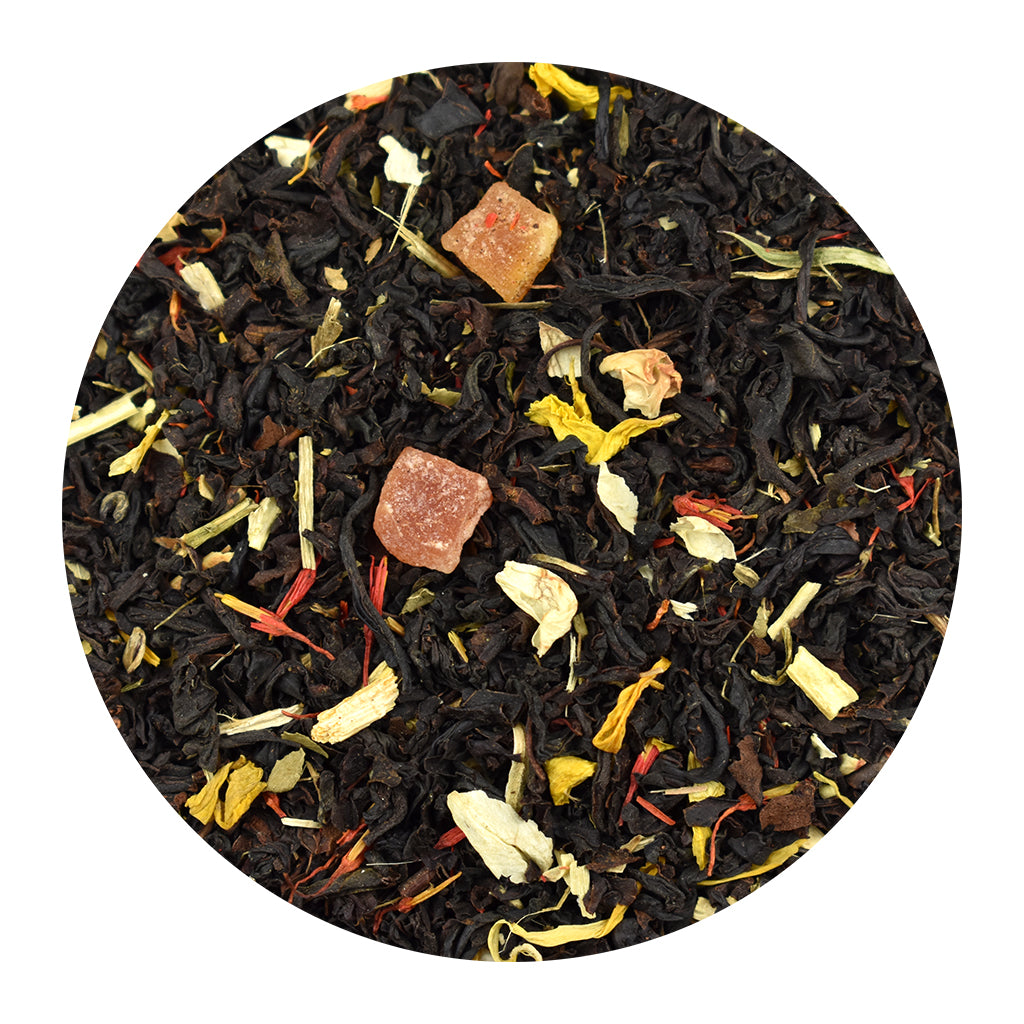 A circular close-up of passion fruit loose loose-leaf black tea blend on a white background
