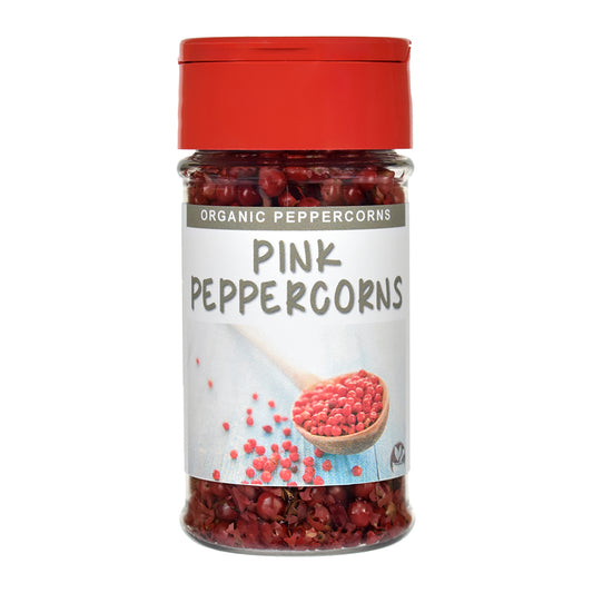 Jar of organic pink peppercorns with a red lid on a white background