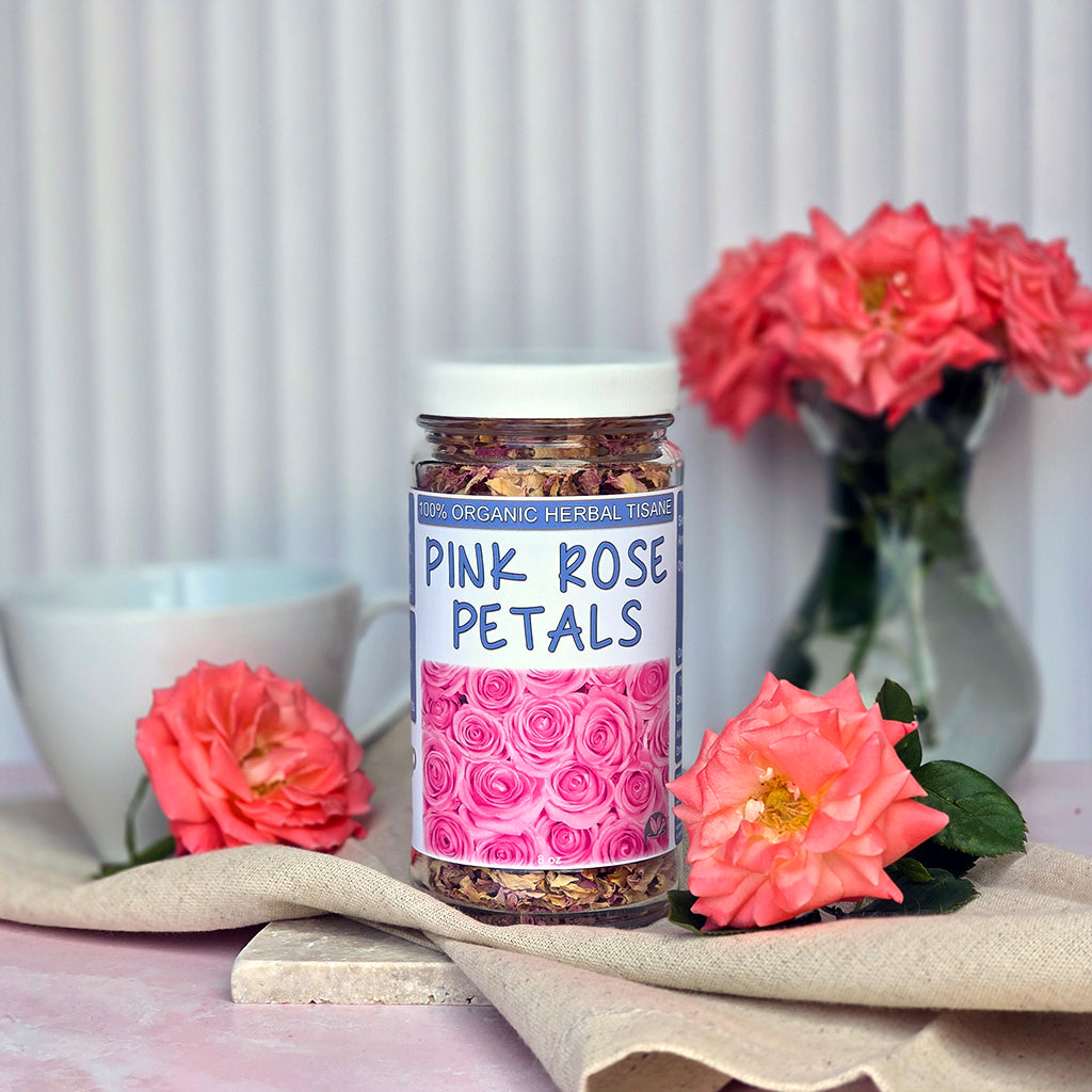 Jar of Herb Stop Pink Rose Petals tea with roses on a table