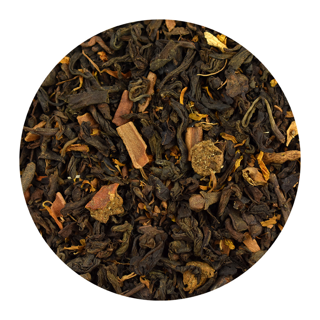 Close-up of Pumpkin Spice Pu-Erh black tea leaves on a white background
