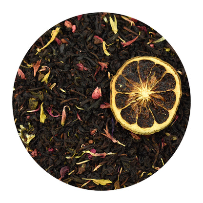 Raspberry Earl Grey black tea leaves with dried bergamot slice on a white background