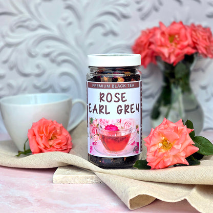 Jar of Herb Stop Rose Earl Grey Black Tea with a tea cup and roses on a decorative surface