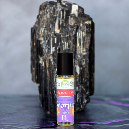 Scorpion Aromatherapy Roll-On bottle in front of a large black tourmaline crystal on a dark surface.