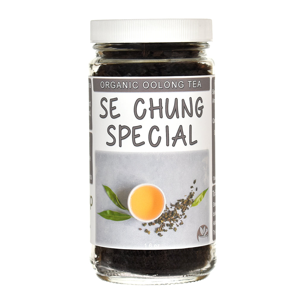 A glass jar of Se Chung Special Organic Oolong Tea with a white screw cap and a gray label featuring a tea leaf illustration and a cup of tea.