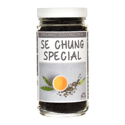 A glass jar of Se Chung Special Organic Oolong Tea with a white screw cap and a gray label featuring a tea leaf illustration and a cup of tea.