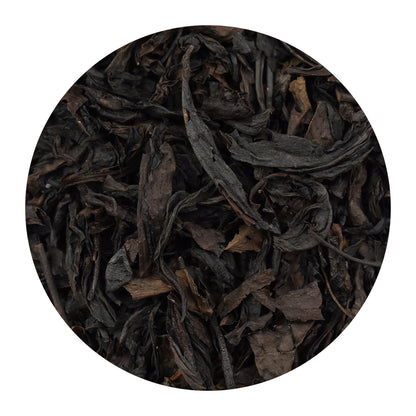 A circular close-up of dark, dried Se Chung Special Oolong loose leaf tea leaves, shown on a plain white background.