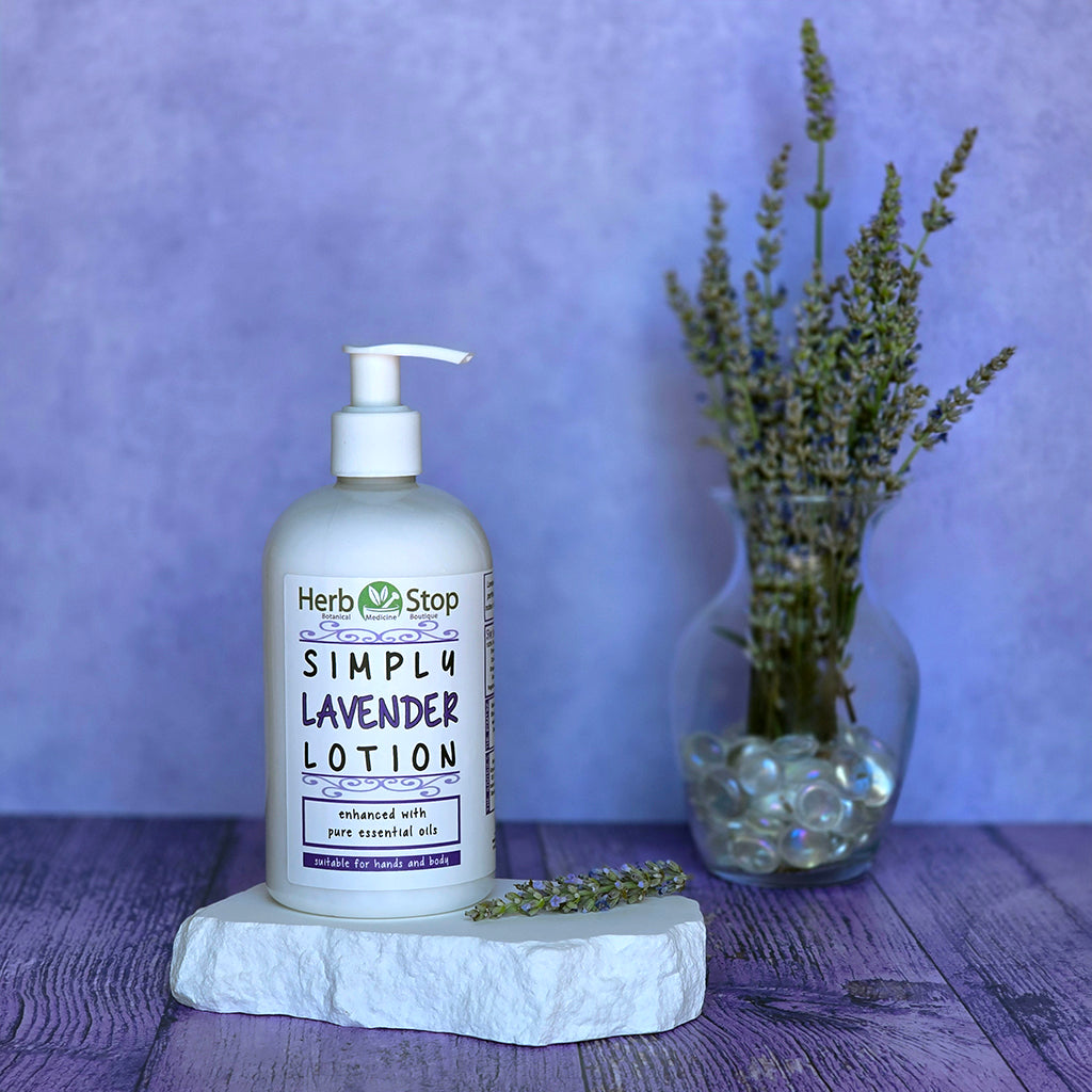 Herb Stop Simply Lavender Lotion bottle on a stone coaster with lavender flowers in the background
