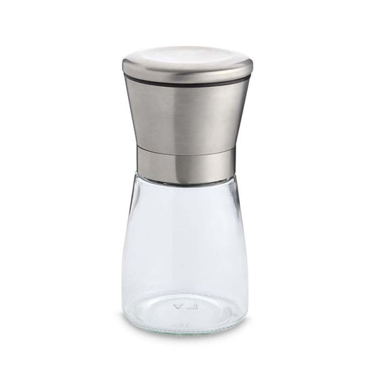 Clear glass spice jar with silver metal grinder lid on a white background