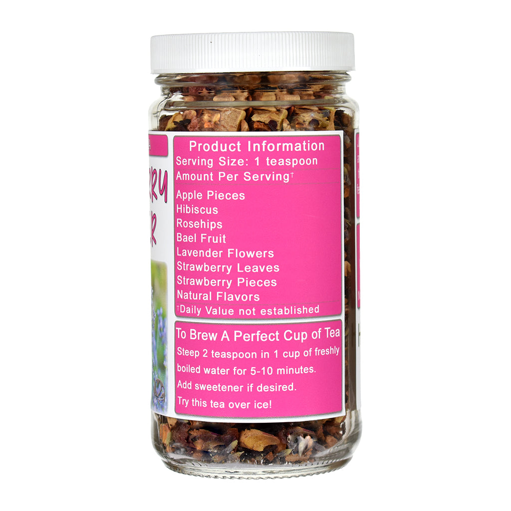 A jar of Strawberry Lavender herbal tea blend with a white lid and a bright pink label. The jar contains a mixture of dried flowers, leaves, and fruit pieces.