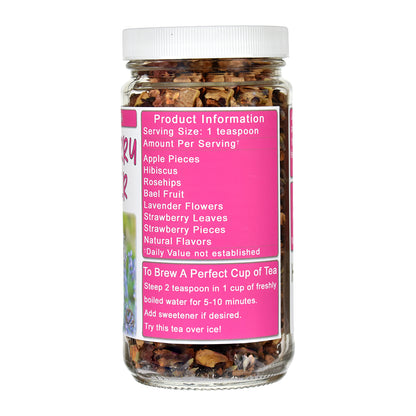 A jar of Strawberry Lavender herbal tea blend with a white lid and a bright pink label. The jar contains a mixture of dried flowers, leaves, and fruit pieces.