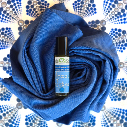 Throat Chakra Aromatherapy Roll-On on a blue cloth with a mandala background