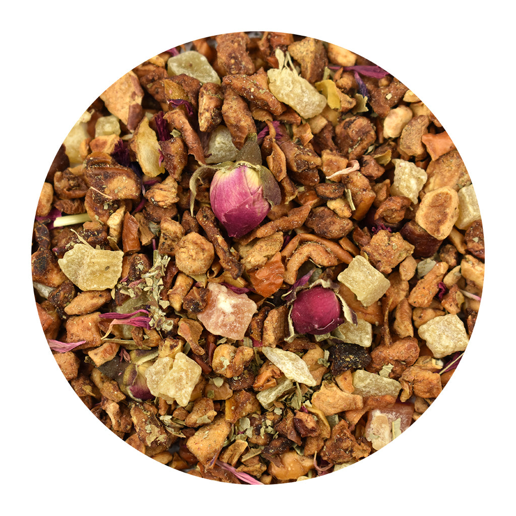A circular close-up of Vanilla Cafe loose herbal tea blend featuring dried fruits, small green leaves, and two pink rose buds on a white background.
