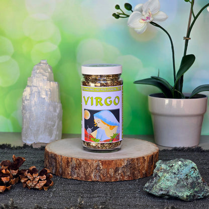 Jar of Virgo Astrological Tea on a wooden stand with decorative elements like crystals and an orchid.