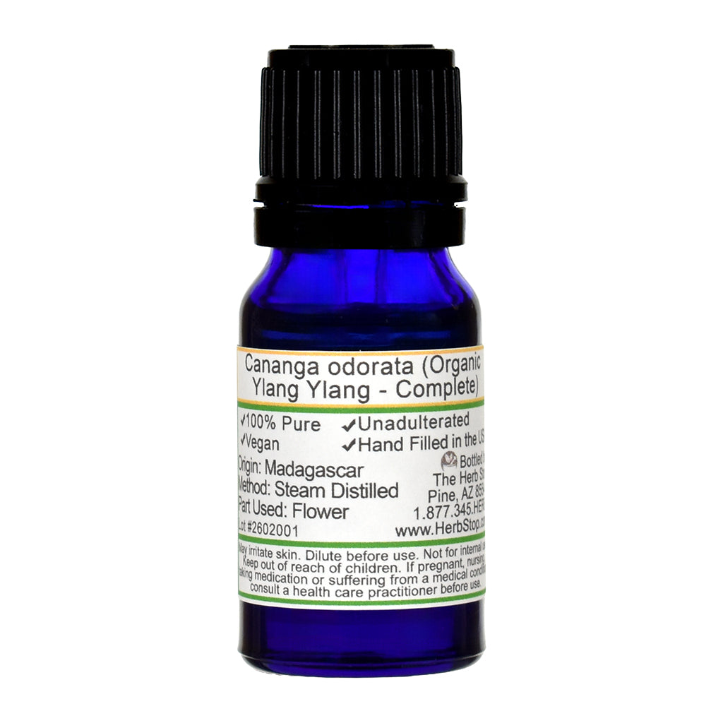 Blue bottle of ylang ylang complete essential oil with a label on a white background