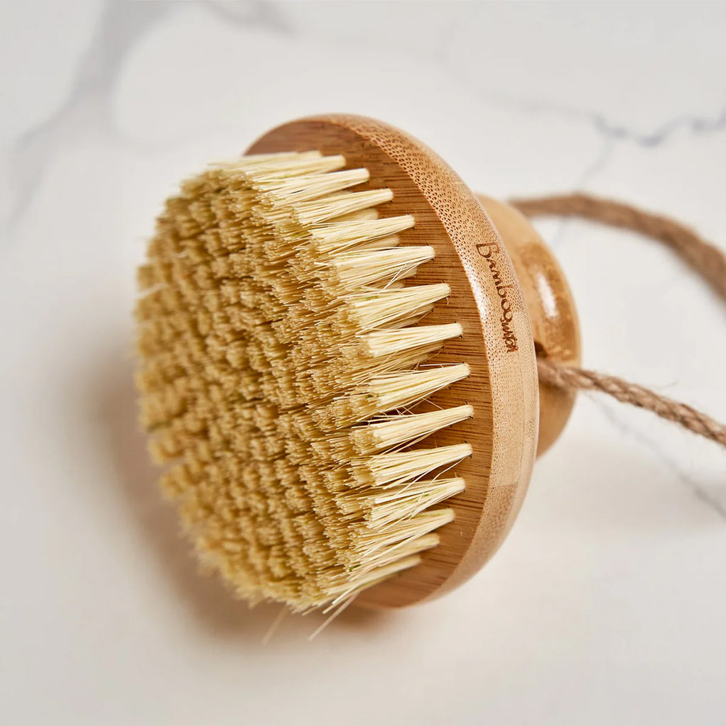 Bamboo body brush with natural bristles on a light background