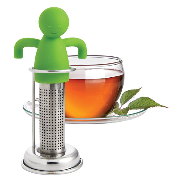 Silicone Tea Man with Drip Stand next to cup of tea